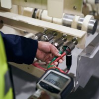 Image depicts a Woodward Group professional conducting fixed wire testing.